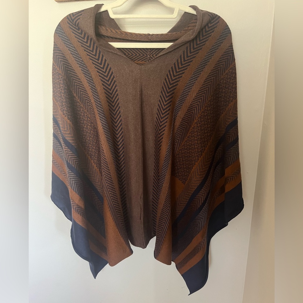Dark brown, navy, and rust colored poncho sweater. Kerisma